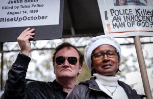 NEW YORK, NY - OCTOBER 24: Director Quentin Tarantino holds a banner as attends a rally to denounce police brutality in Washington Square Park October 24, 2015 in New York City. The rally is part of a three-day demonstration against officer-involved abuse and killing. (Photo by Kena Betancur/Getty Images)