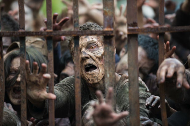 Zombies struggle behind a gate in AMC's "The Walking Dead"