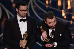 Singer Sam Smith (R) and Composer Jimmy Napes accept their award for Best Song, Spectre on stage at the 88th Oscars on February 28, 2016 in Hollywood, California. AFP PHOTO / MARK RALSTON / AFP / MARK RALSTON        (Photo credit should read MARK RALSTON/AFP/Getty Images)