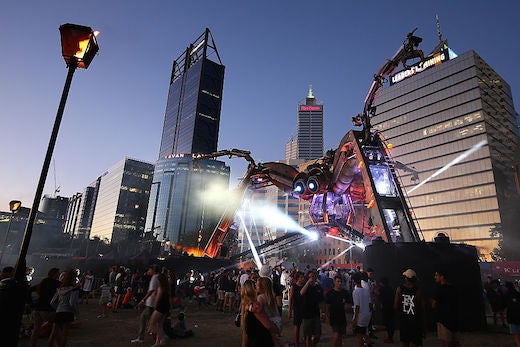 PERTH, AUSTRALIA - NOVEMBER 27: People dance to the music around the Arcadia Spider at Elizabeth Quay on November 25, 2016 in Perth, Australia. The Arcadia spider is made out of recycled military and industrial machinery and is over 15 metres tall. Arcadia Australia is exclusive to Perth, with events and shows taking place November 25 - 27. (Photo by Paul Kane/Getty Images)