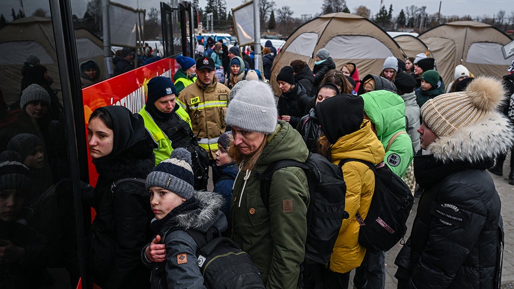 MEDYKA, POLAND - MARCH 04: People who fled the war in Ukraine board a bus after crossing the Polish Ukrainian border on March 04, 2022 in Medyka, Poland. Over one million and a half people have left Ukraine since Russia launched its military invasion 10 days ago. Ukrainian authorities are forbidding men aged between 18 and 60 from leaving and calling on them to fight. Meanwhile Russia is continuing a heavy-handed campaign of attacking major cities such as Kyiv and Kharkiv and breaking cease fires agreements. (Photo by Omar Marques/Getty Images)