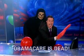 Stephen Colbert Channels Miley Cyrus: Whip Out Foam Fingers and Stick Out Your Tongue — Obamacare Is Dead! (Video)