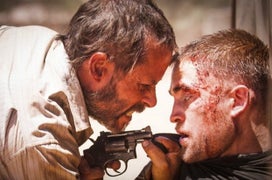 Guy Pearce Drags Around a Busted Up Robert Pattinson in ‘The Rover’ Trailer (Video)