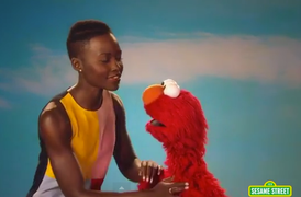 Lupita Nyong’o Teaches Elmo About The Power of Skin and Tickles (Video)