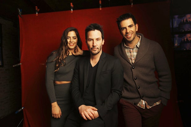 "Knock Knock" stars Lorenza Izzo and Keanu Reeves with director Eli Roth (l-r), photographed by Patrick Fraser at TheWrap's Kia photobooth during the 2015 Sundance Film Festival in Park City, Utah on Jan. 23, 2015. "Knock Knock" stars Lorenza Izzo and Keanu Reeves with director Eli Roth (l-r), photographed by Patrick Fraser at TheWrap's Kia photobooth during the 2015 Sundance Film Festival in Park City, Utah on Jan. 23, 2015.