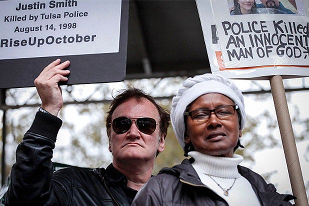 NEW YORK, NY - OCTOBER 24: Director Quentin Tarantino holds a banner as attends a rally to denounce police brutality in Washington Square Park October 24, 2015 in New York City. The rally is part of a three-day demonstration against officer-involved abuse and killing. (Photo by Kena Betancur/Getty Images)