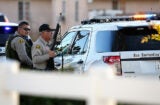 SAN BERNARDINO, CA - DECEMBER 02: Law enforcement hold a position along Mountain View Avenue as they pursue suspects of the shooting at the Inland Regional Center on December 2, 2015 in San Bernardino, California. Police continue to search for suspects in the shooting that left at least 14 people dead and another 17 injured (Photo by Sean M. Haffey/Getty Images)