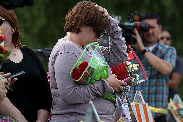 A woman holds flowers outside the site of the San Bernardino mass shooting