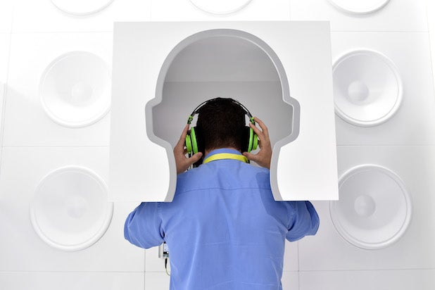 A man listens to streaming subscription music on a pair of headphones