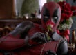 A still from an ad for "Deadpool," showing the title character holding a rose