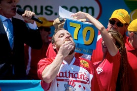 Joey Chestnut Wolfs Down Record 70 Hot Dogs to Reclaim Nathan’s Famous Championship