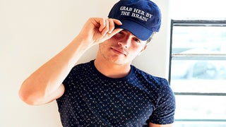 Gregg Sulkin Catches Hell for ‘Grab Her By the Brain’ Hat