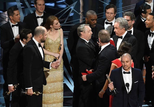HOLLYWOOD, CA - FEBRUARY 26: 'La La Land' producer Fred Berger (R) speaks at the microphone as production staff consult behind him regarding a presentation error of the Best Picture award (later awarded to 'Moonlight') onstage during the 89th Annual Academy Awards at Hollywood & Highland Center on February 26, 2017 in Hollywood, California. (Photo by Kevin Winter/Getty Images)