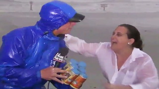Texas Woman Interrupts Fox News Reporter During Hurricane Harvey, Hands Him a Six-Pack (Video)