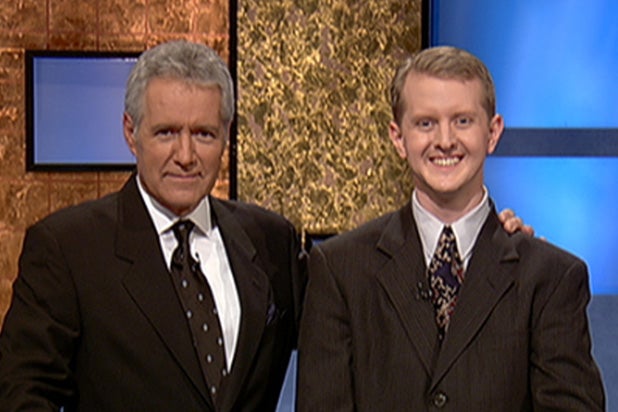 Jeopardy host Alex Trebek, (L) poses contestant Ken Jennings after his earnings from his record breaking streak on the gameshow surpassed 1 million dollars July 14, 2004 in Culver City, California