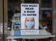 Signage outside a store in Glendale requiring masks