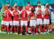 teammates surrounding christian eriksen