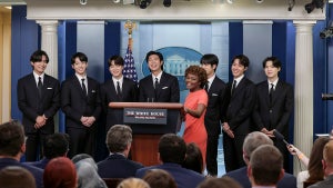 WASHINGTON, DC - MAY 31: White House Press Secretary Karine Jean-Pierre welcomes V, Jungkook, Jimin, RM, Jin, J-Hope and Suga of the South Korean pop group BTS to the daily press briefing at the White House on May 31, 2022 in Washington, DC. BTS met with U.S. President Joe Biden to discuss Asian inclusion and representation, and to discuss the recent rise in anti-Asian hate crimes. (Photo by Kevin Dietsch/Getty Images)