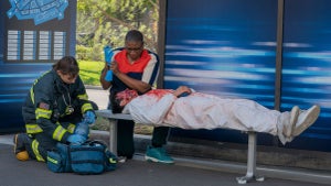 9-1-1: Aisha Hinds (center) and guest star Samuel Walker (laying down) in the “Tomorrow” episode of 9-1-1 airing Monday, Oct. 24 (8:00-9:00 PM ET/PT) on FOX. CR: Jack Zeman/ FOX