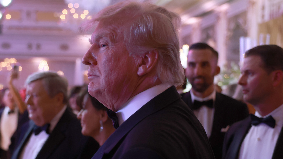 Donald Trump greets people as he arrives for a New Years event at his Mar-a-Lago home