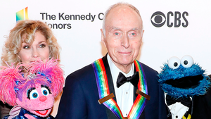 Sesame Street co-founder Lloyd Morrisett with Sesame Street characters Abby Cadabby and Cookie Monster attend the 42nd Annual Kennedy Center Honors Kennedy Center