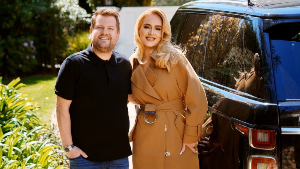 Adele standing next to James Corden