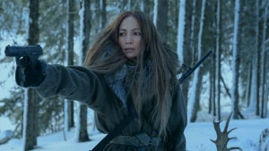 Jennifer Lopez fires a gun in the wilderness in a still from Netflix's "The Mother"
