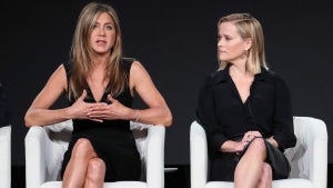 Jennifer Aniston (L) and Reese Witherspoon of "The Morning Show" speak on stage during the Apple TV+ segment of the 2020 Winter TCA Tour (Getty Collection)
