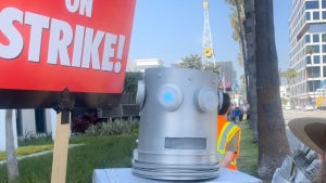 A picketer wearing a robot costume works the picket lines at Universal Studios on Monday, May 6, 2023.