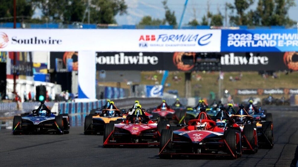 Race cars driving on a track.