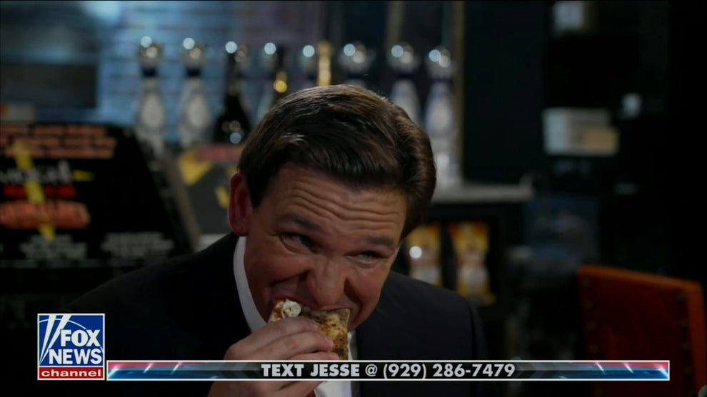 Ron DeSantis Says The Left Doesn't 'Want People to be Happy' While Awkwardly Eating Pizza