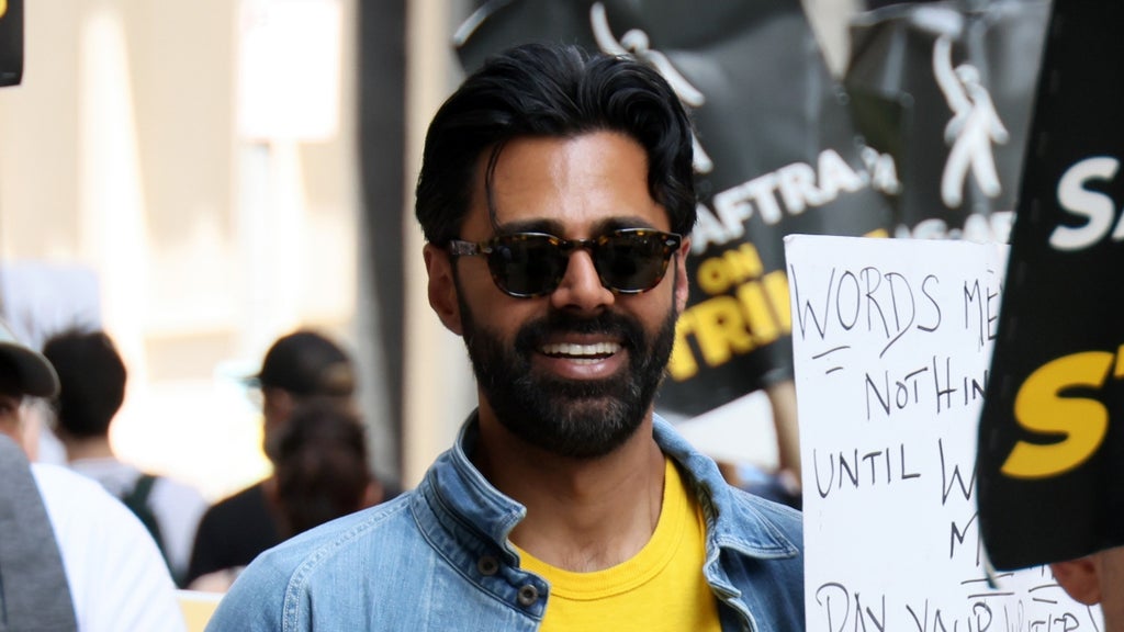 Hasan Minhaj (L) joins SAG-AFTRA members on the picket line outside of Netflix and Warner Bros on July 21, 2023 in New York City. 
