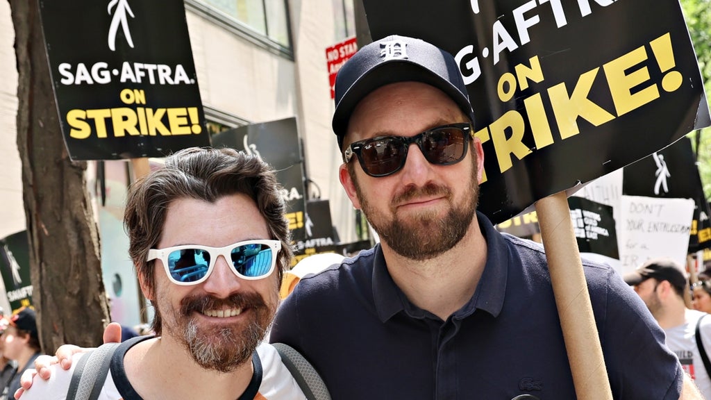 Jordan Klepper (R) joins SAG-AFTRA members on the picket line outside of 30 Rockefeller Plaza on July 20, 2023 in New York City.