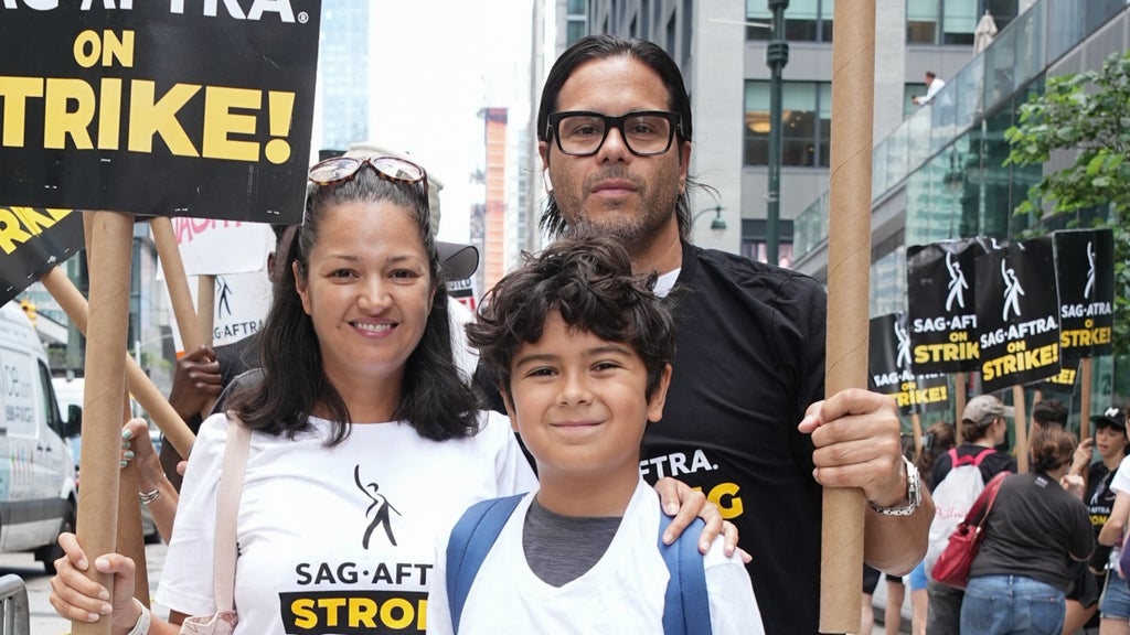 Paula Garces, son Antonio Andres Hernandez and husband Antonio Hernandez join the picket line In New York City on July 21, 2023 in New York City.