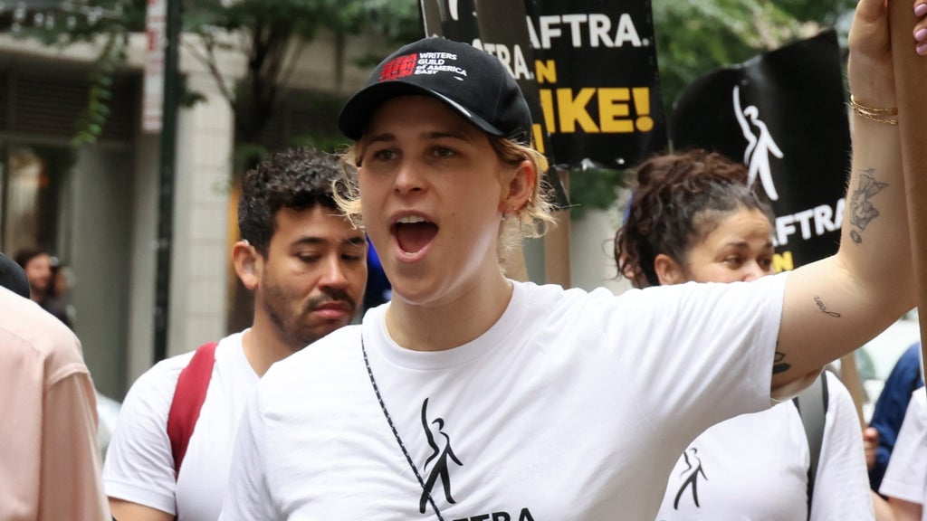 Tommy Dorfman (C) joins SAG-AFTRA members on the picket line outside of Netflix and Warner Bros on July 21, 2023 in New York City.