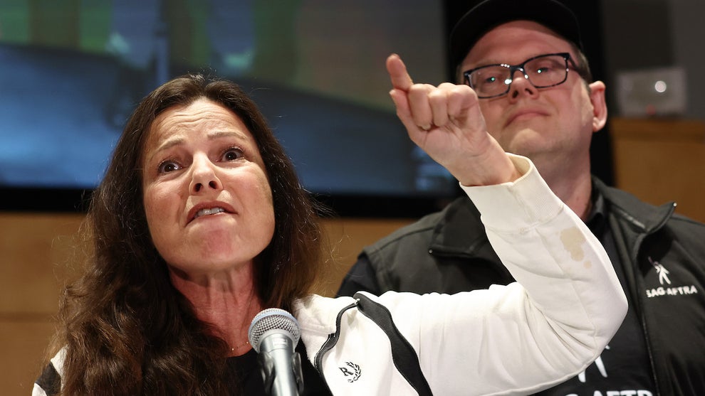 SAG-AFTRA President Fran Drescher speaks as National Executive Director Duncan Crabtree-Ireland looks on at a press conference announcing a strike against Hollywood studios on July 13.