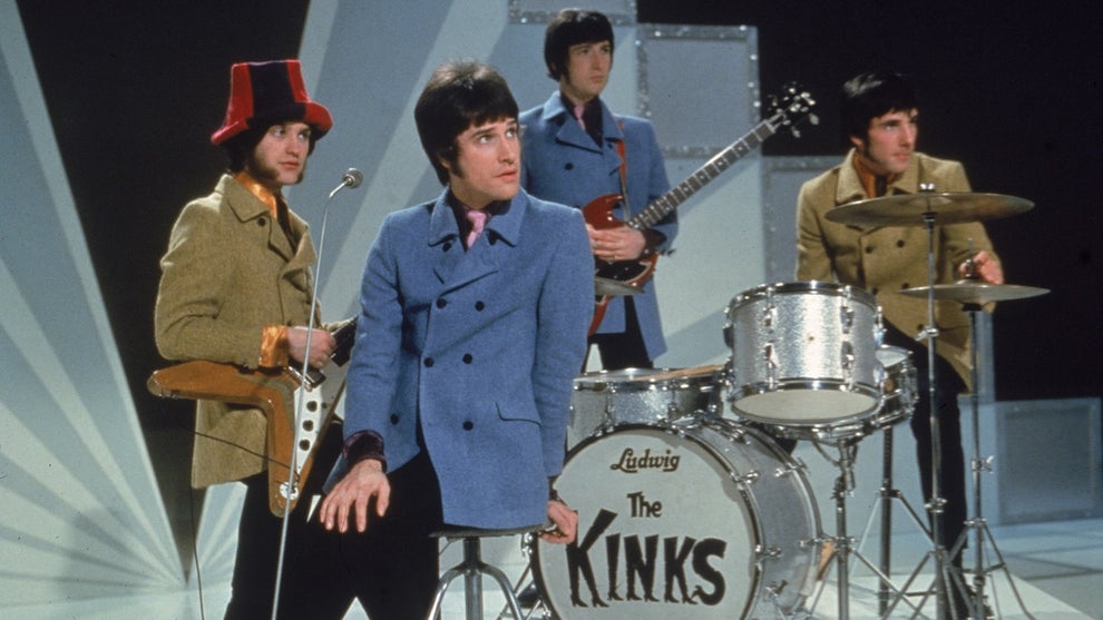 Members of the band The Kinks on stage with instruments