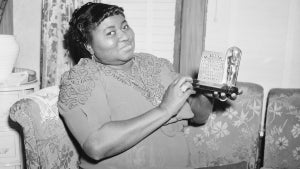 Hattie McDaniel is shown with the statuette she received for her portrayal in "Gone With The Wind." (Credit: The Academy)
