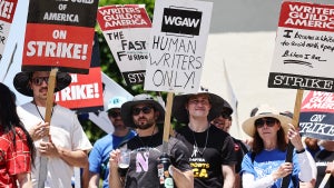A sign reads "Human Writers Only!" as striking WGA members picket outside Paramount Studios in July. (Photo by Mario Tama/Getty Images)