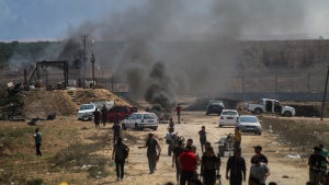The aftermath of an attack in Israel with smoke billowing.