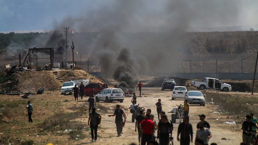 The aftermath of an attack in Israel with smoke billowing.