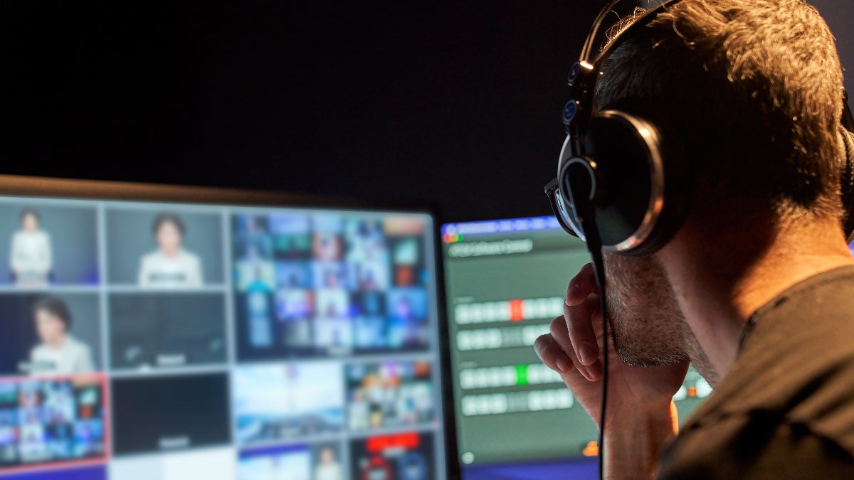 Man looking at screen full of channels