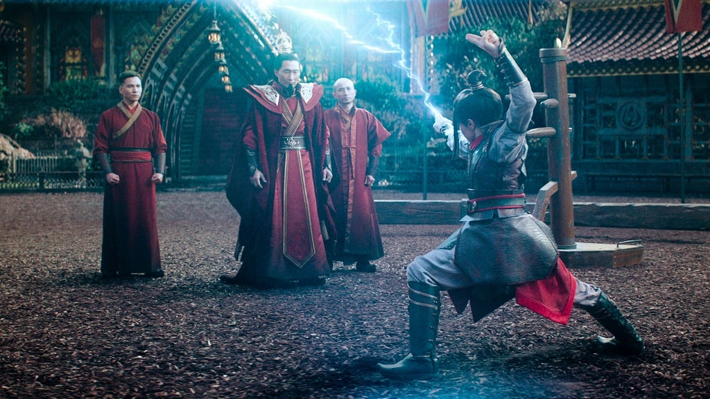 Elizabeth Yu as Azula (right) whips out blue lightning to show her father, Fire Lord Ozai (Daniel Dae Kim, left)