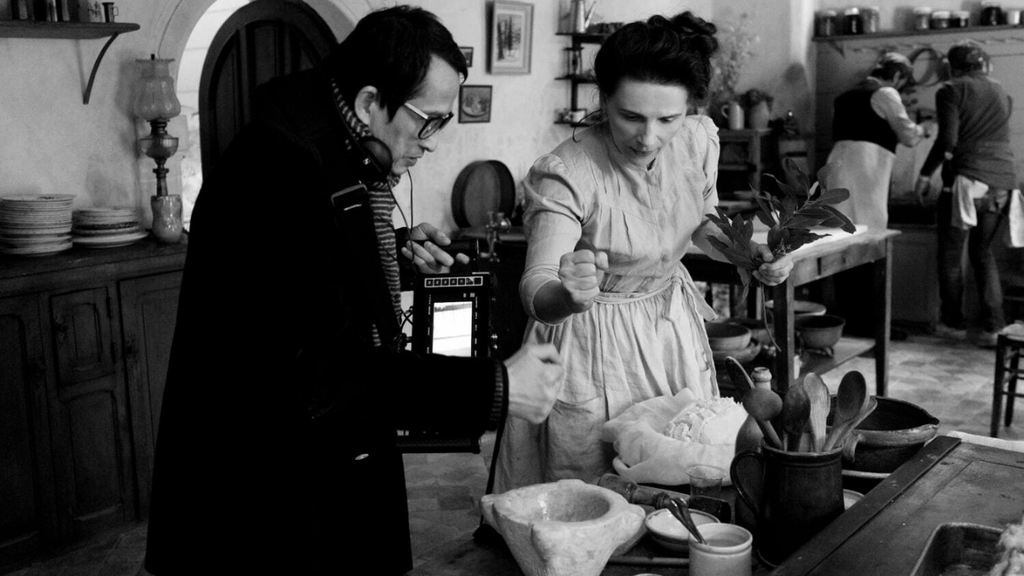 Director Tran Anh Hung and Juliette Binoche on the set of "The Taste of Things" (IFC Films)