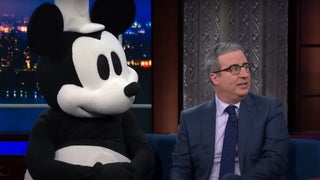 John Oliver Dares Disney to Sue as He Brings Steamboat Willie on Colbert: ‘I’m Legally Indestructible’ | Video
