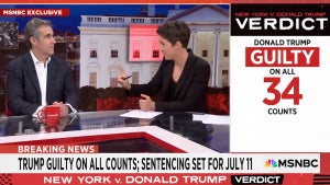 A man and a woman sit at a cable news desk. They are Michael Cohen and Rachel Maddow. Graphics on screen talk about Trump being found guilty on 34 counts.