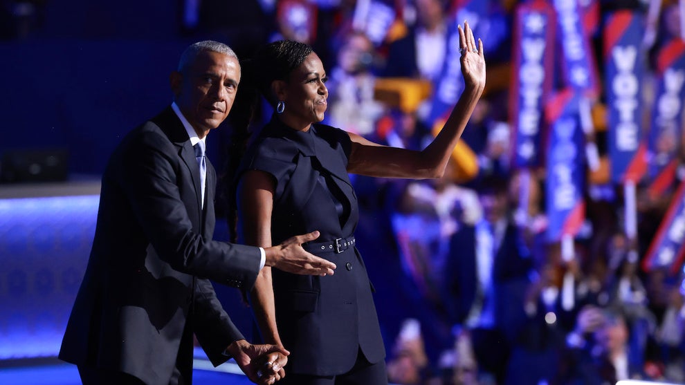 Former U.S. President Barack Obama gestures to former first lady Michelle Obama as he arrives to speak on stage during the second day of the Democratic National Convention at the United Center (Credit: Joe Raedle/Getty Images)