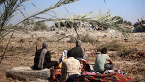 Palestinians collect their belongings and inspect the destruction caused by Israeli airstrikes in eastern Deir al-Balah in central Gaza Strip on August 29, 2024, amid the ongoing conflict between Israel and the Palestinian Hamas movement