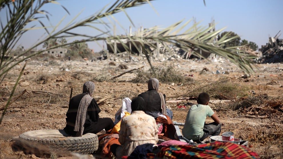 Palestinians collect their belongings and inspect the destruction caused by Israeli airstrikes in eastern Deir al-Balah in central Gaza Strip on August 29, 2024, amid the ongoing conflict between Israel and the Palestinian Hamas movement