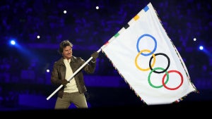 Actor Tom Cruise holds the Olympic flag during the Closing Ceremony of the Olympic Games Paris 2024 at Stade de France on August 11, 2024 in Paris, France